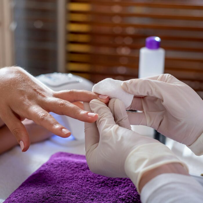 Woman doing manicure in the beauty salon